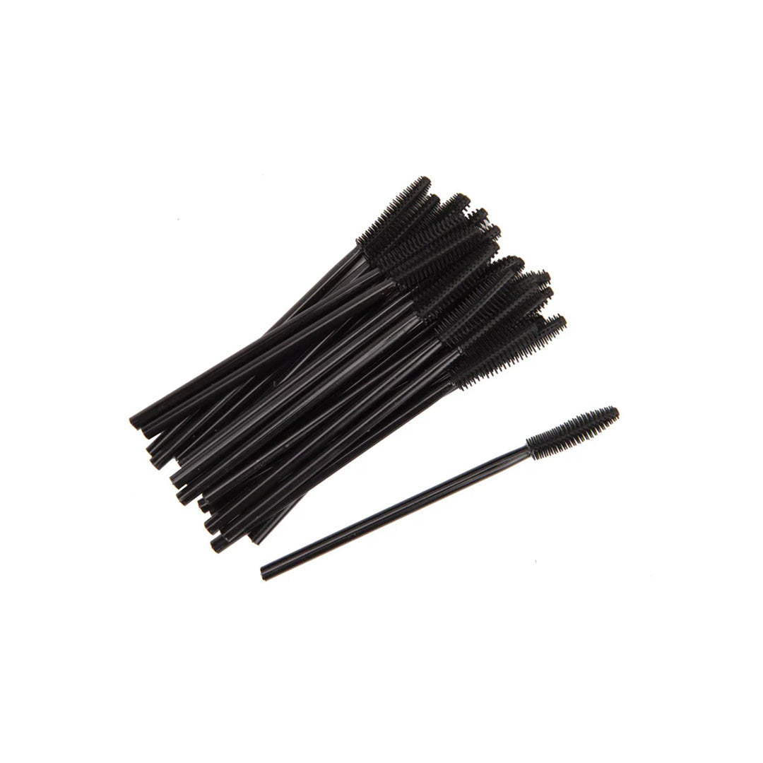Multiple black mascara brushes on a white background