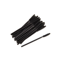 Multiple black mascara brushes on a white background