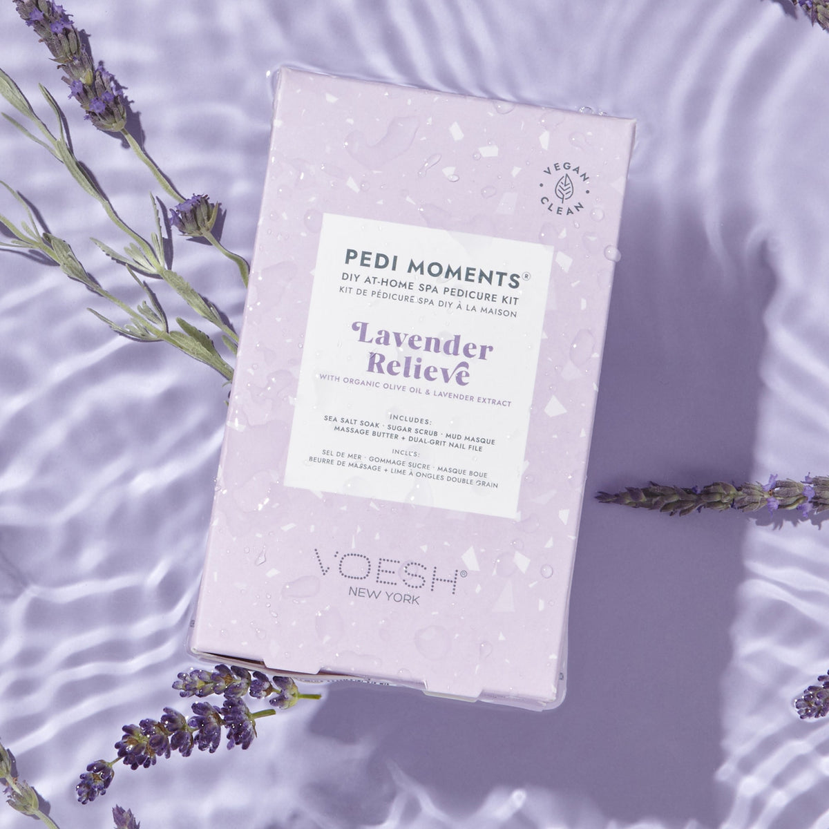 VOESH Pedi Moments Lavender Relieve pedicure kit on a purple background with lavender flowers.